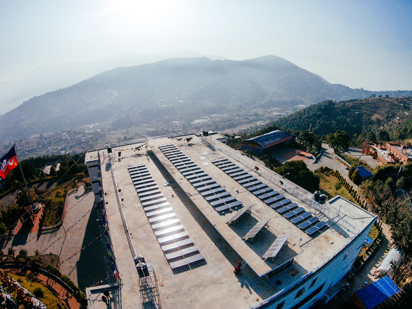 Aerial view of the rooftop solar array at Druk Amitabha Mountain, overlooking the Kathmandu valley